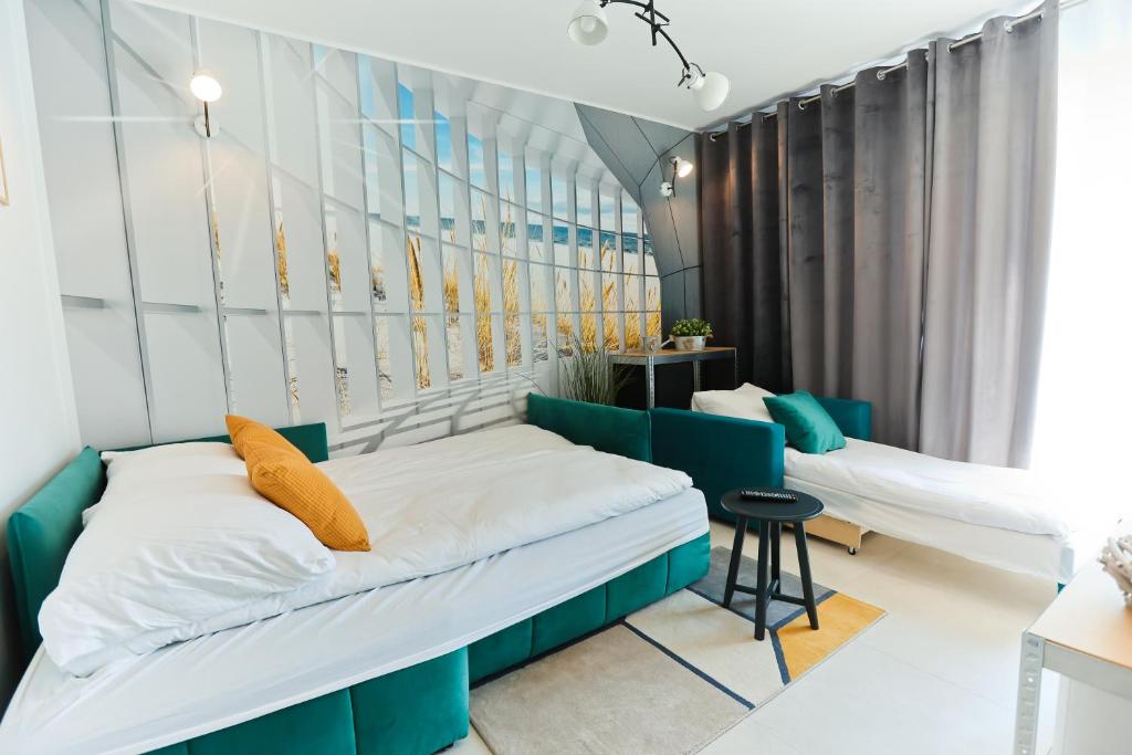 Posteľ alebo postele v izbe v ubytovaní M&K Apartamenty - Morska Przystań