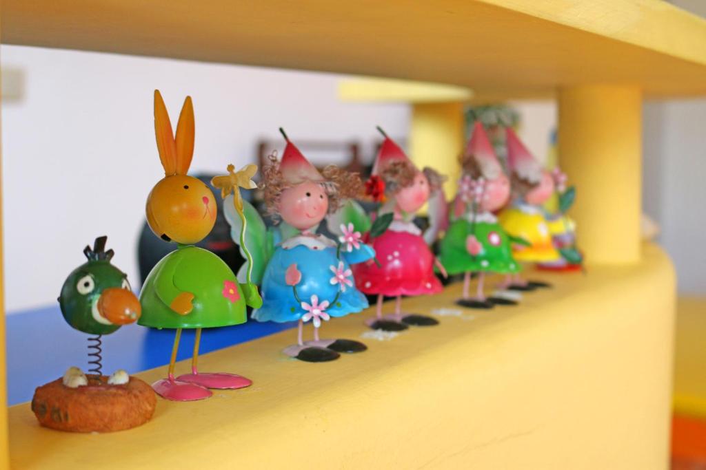 a row of toy figurines on a shelf at Haisu Homestay in Eluan