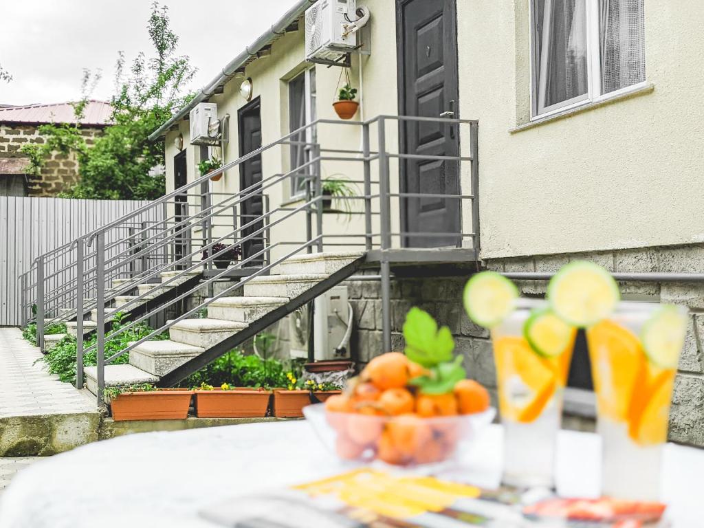 a table with a bowl of fruit on top of a building at KUTAISI-Maemani in Kutaisi