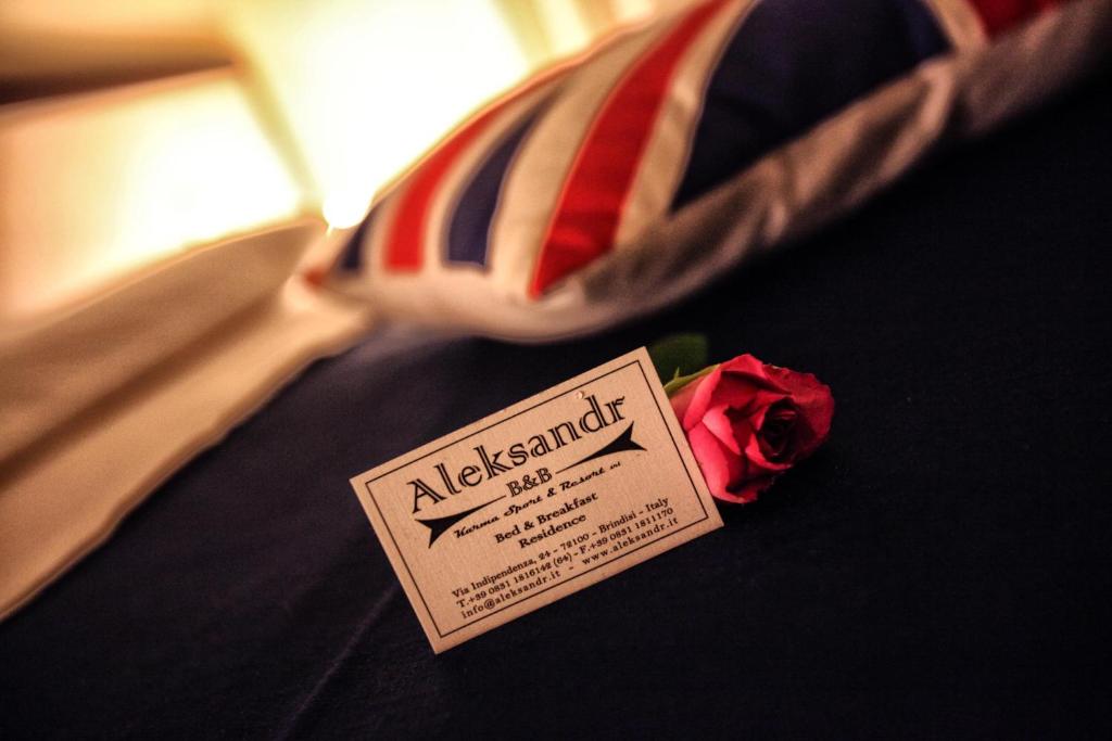 a close up of a tie and a rose at Aleksandr in Brindisi