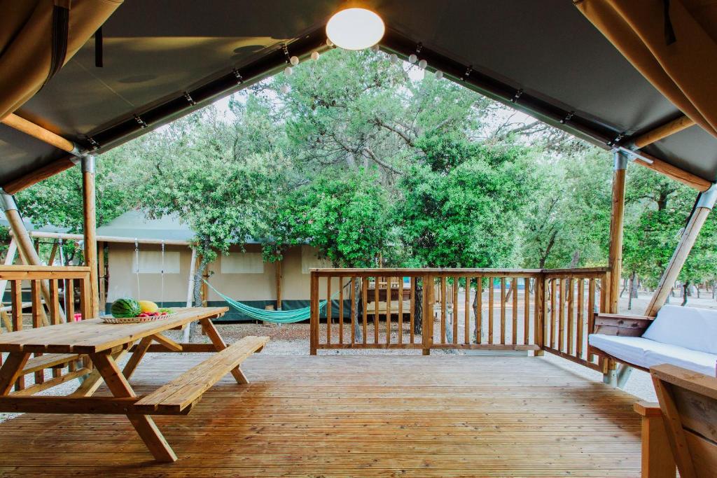 比奧格勒納莫魯的住宿－Glamping Camp Soline，带野餐桌和吊床的屏蔽门廊