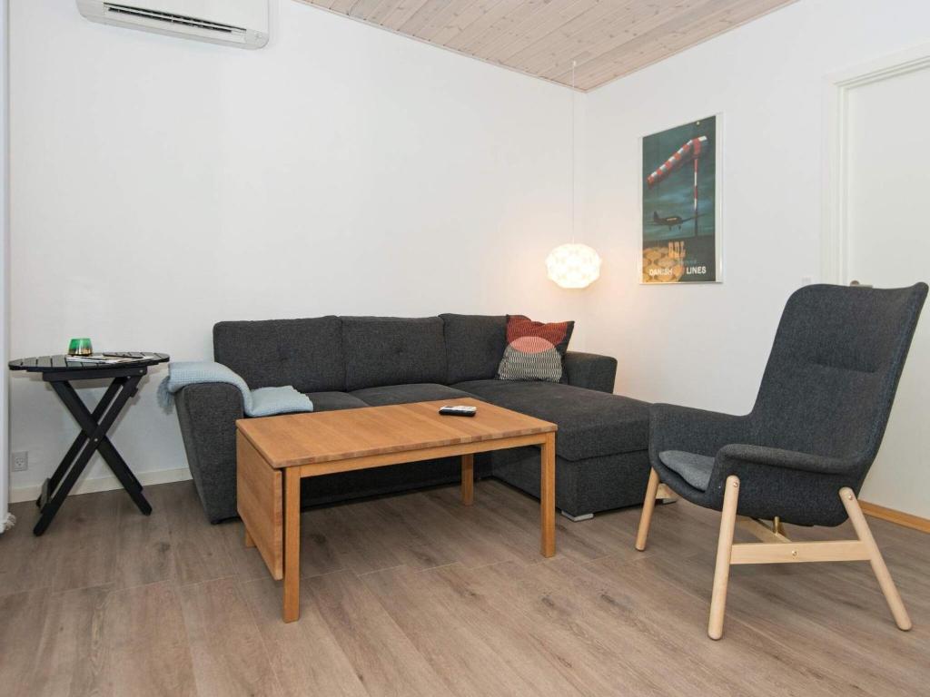 a living room with a couch and two chairs and a table at 5 star holiday home in Knebel in Knebel