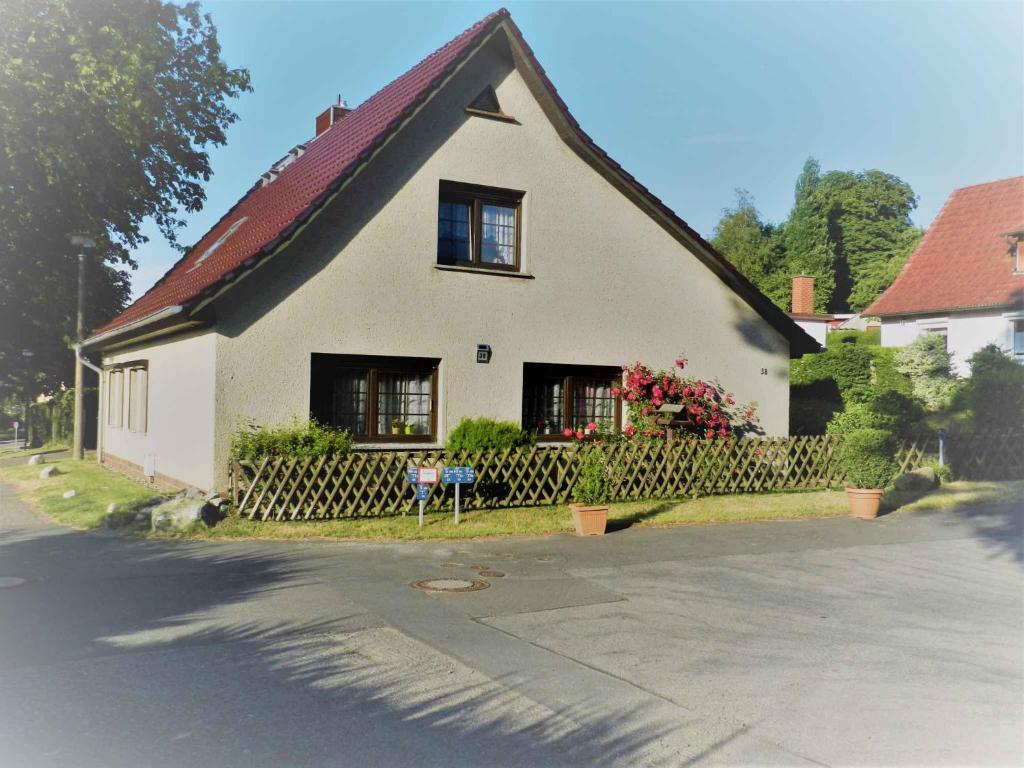 een wit huis met een zwart dak en ramen bij Holiday home in Bergen auf Rügen 2852 in Bergen auf Rügen