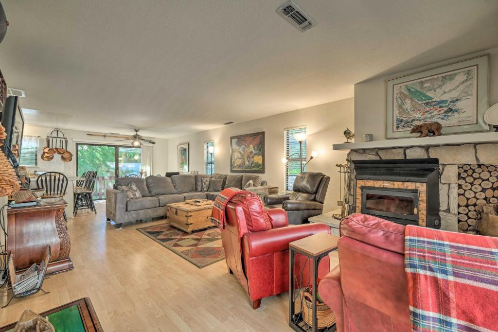 a living room with couches and a fireplace at Pine Mountain Lake Haven with Spacious Deck! in Groveland