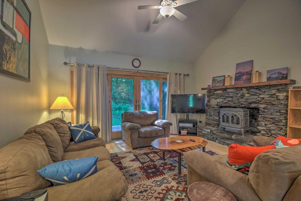 a living room with a couch and a fireplace at Rustic Waitsfield Condo about 1 Mi to Hike and Ski! in Waitsfield
