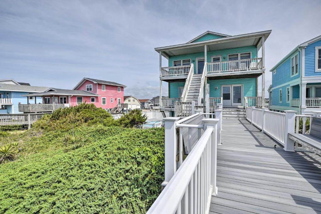 a row of colorful houses on the beach at Large-Group Getaway - Beachfront Home with Pool! in Holden Beach
