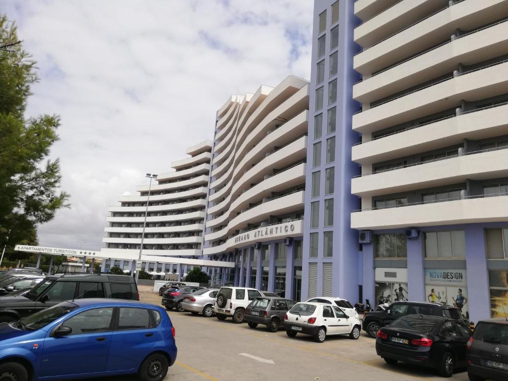 um parque de estacionamento com carros estacionados em frente a edifícios altos em APARTAMENTO VISTA MAR 715 Edificio Oceano Atlantico Apartamentos Turisticos em Portimão