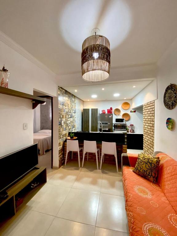 a living room with a couch and a dining room at Casa Maragogi in Maragogi