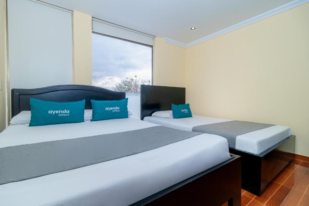 Postel nebo postele na pokoji v ubytování Hotel Ayenda Normandy