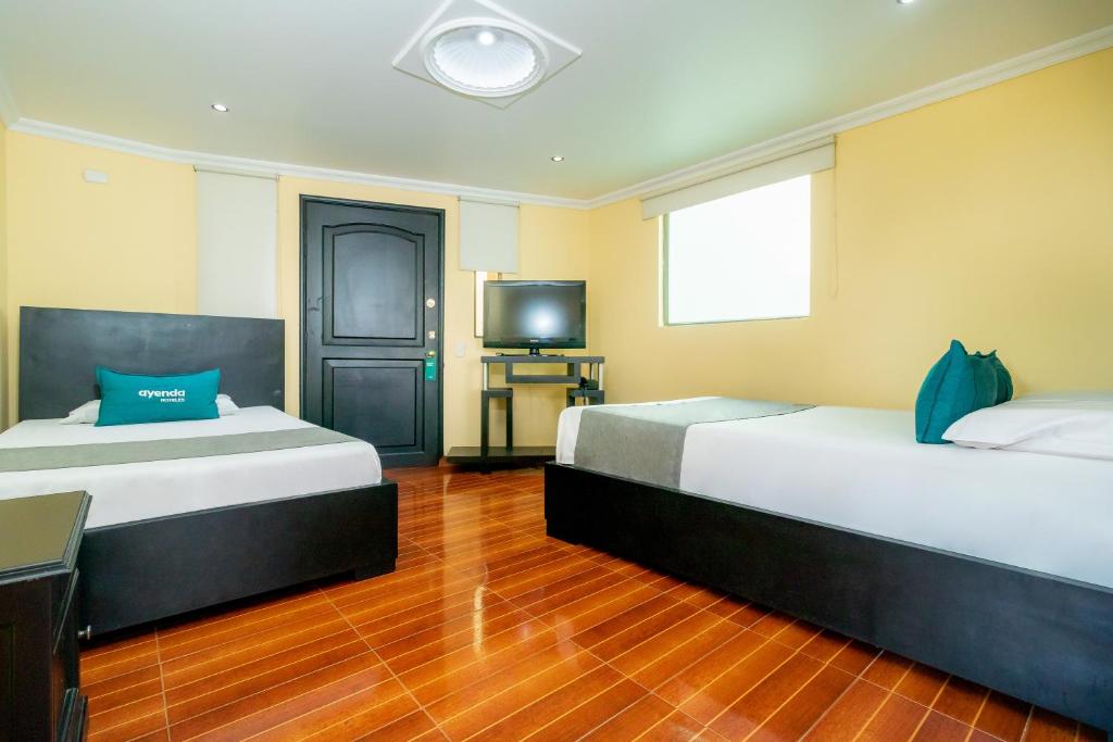 Postel nebo postele na pokoji v ubytování Hotel Ayenda Normandy