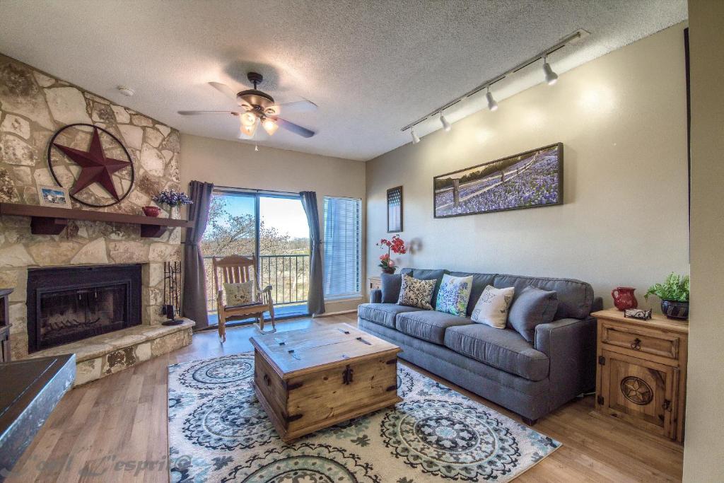 a living room with a couch and a fireplace at Seele Street River Retreat SS B11 in New Braunfels