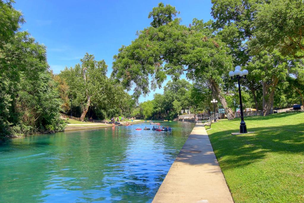 a river in a park with boats on it at Grandmas River Haus RRC A108 in New Braunfels