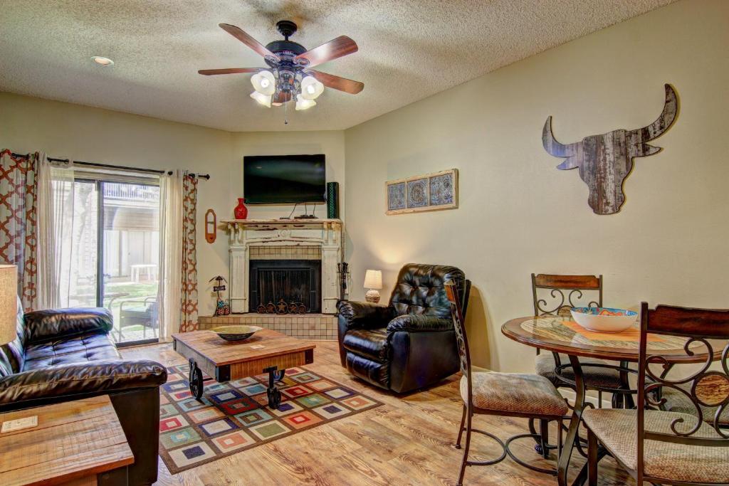 a living room with a couch and a ceiling fan at Go With The Flow CW B103 in New Braunfels