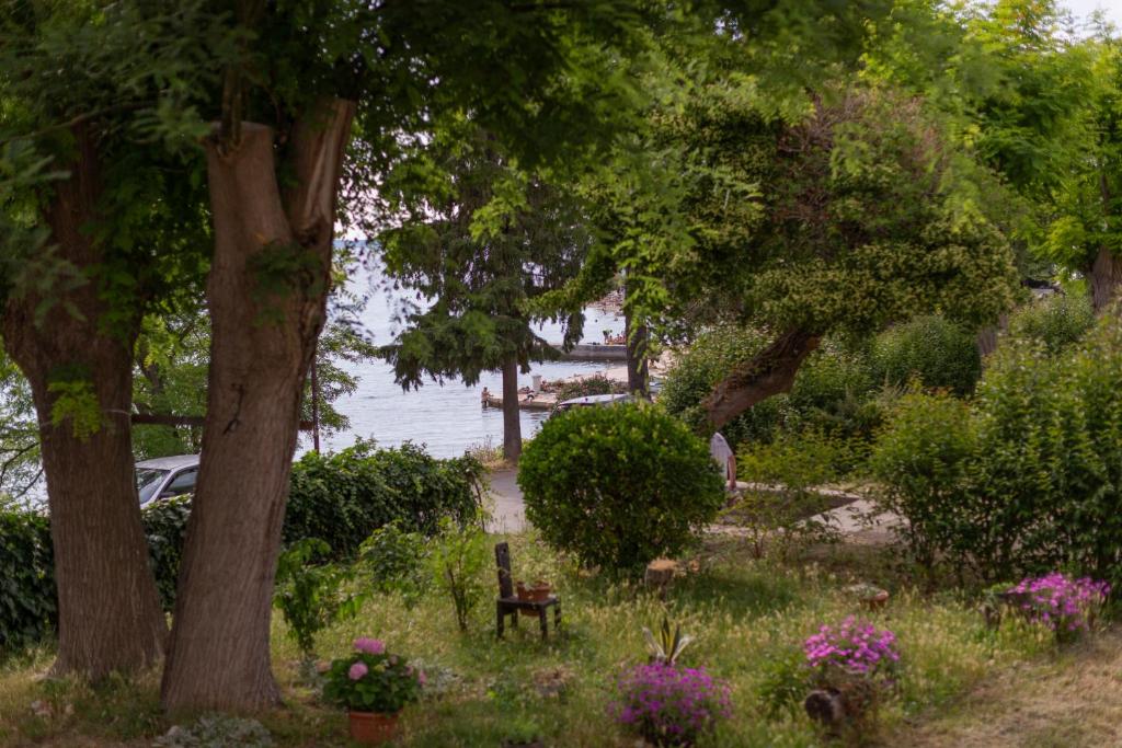 a park with a bench and trees and flowers at Sunset Beach Apartment in Zadar