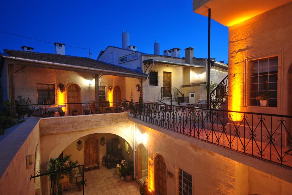 a view of a building with a balcony at night at Hotel Elvan Cave House in Urgup