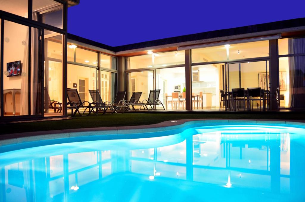 a swimming pool in front of a house at Villas Opal Anfi Tauro in Puerto Rico de Gran Canaria