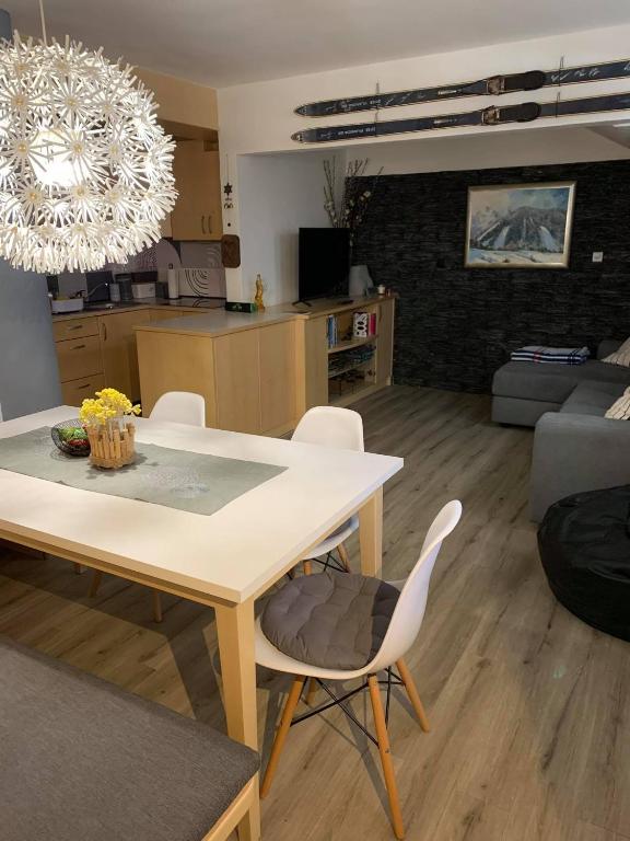 a kitchen and living room with a table and chairs at Skier's cave in Kranjska Gora