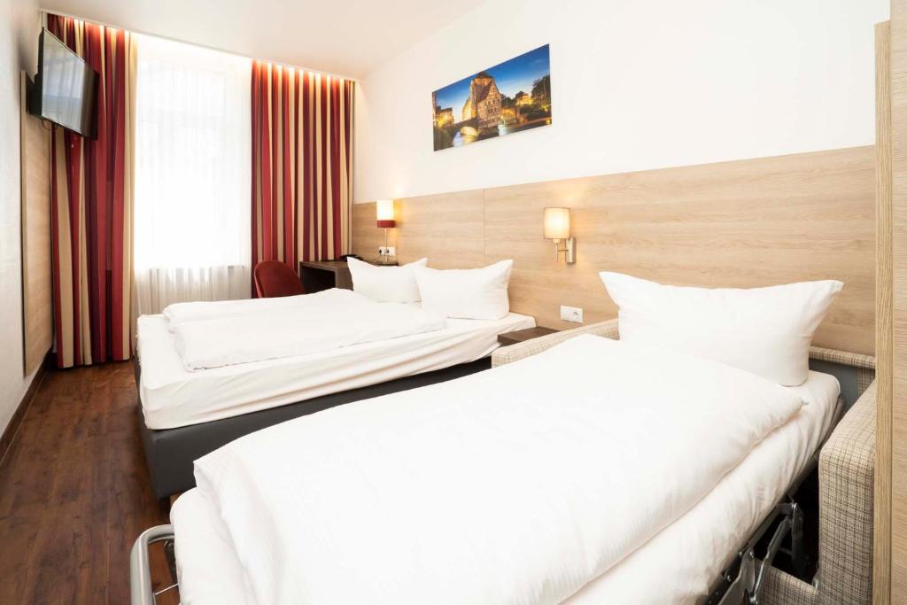 Postel nebo postele na pokoji v ubytování Hotel National