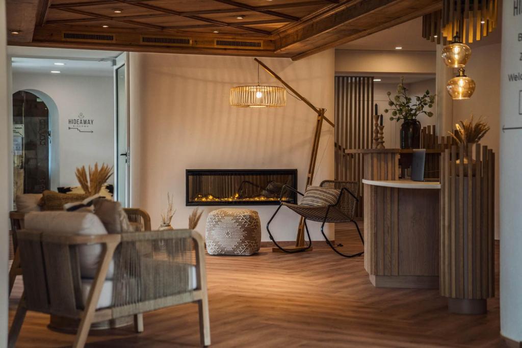 a living room with a fireplace and a couch at Bergrose Hideaway in Strobl