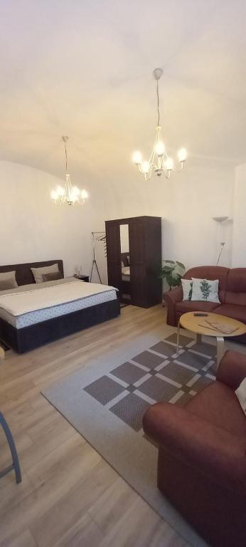 a living room with a bed and a couch at LUNA in Oradea