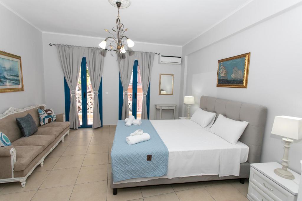 a bedroom with a bed and a couch at The Old Town hall in Parga