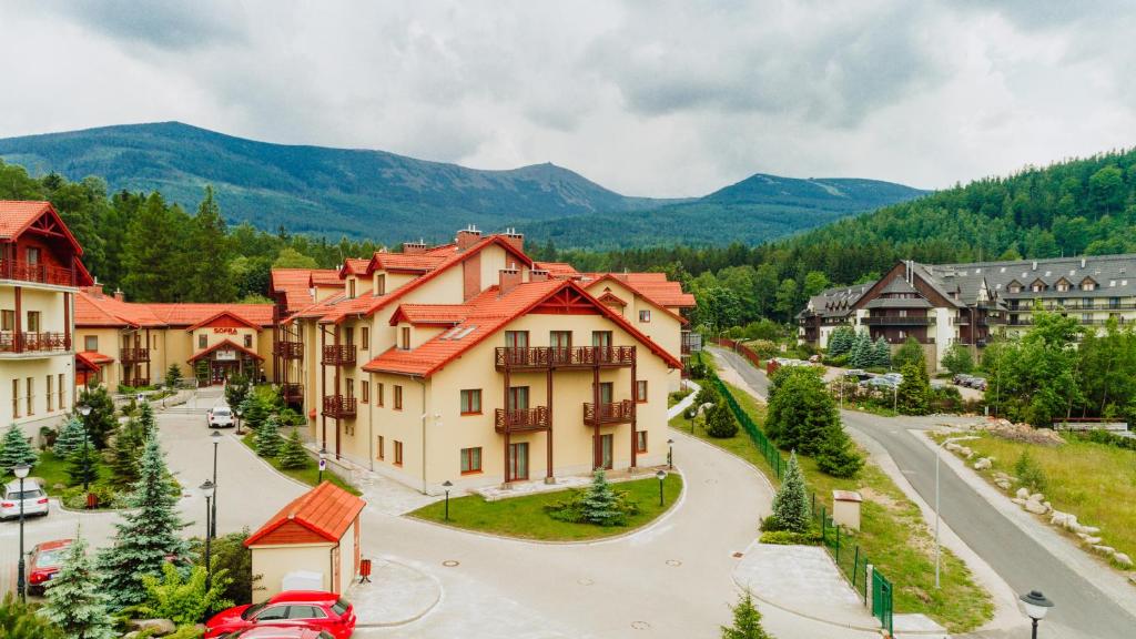a town in the mountains with a street and buildings at Apartamenty Sun & Snow Sofra in Karpacz