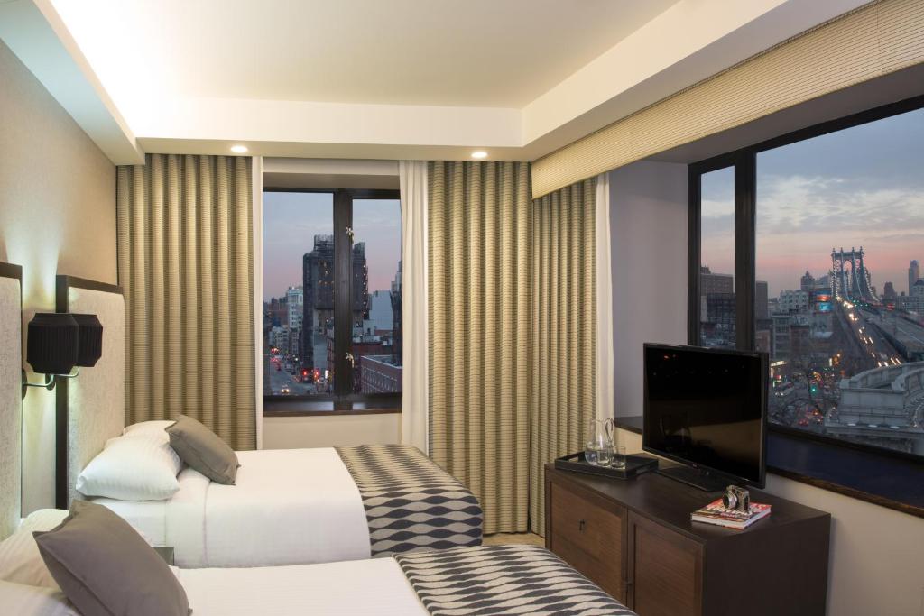 Habitación de hotel con cama y ventana grande en Leon Hotel LES, en Nueva York