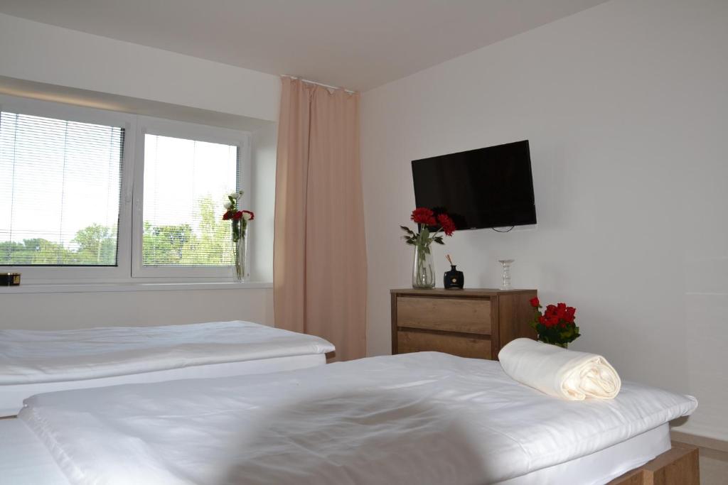 Postel nebo postele na pokoji v ubytování Apartmany u Polanských Lednice