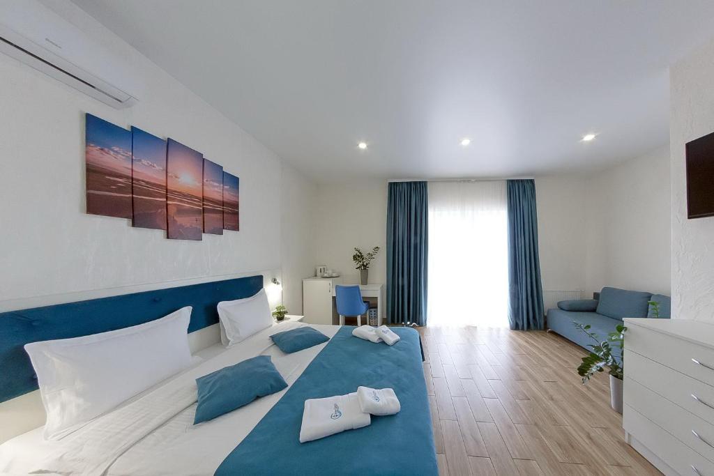 Postel nebo postele na pokoji v ubytování Apart-Hotel Poseidon