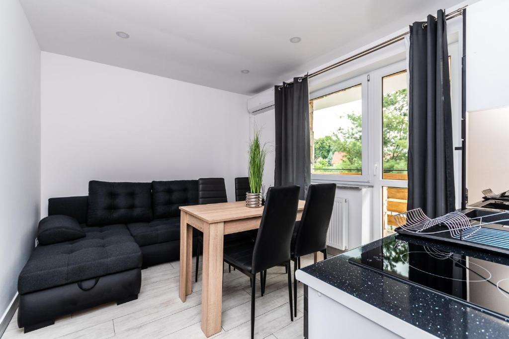 uma sala de estar com uma mesa e um sofá em VIP House Apartamenty em Sztutowo
