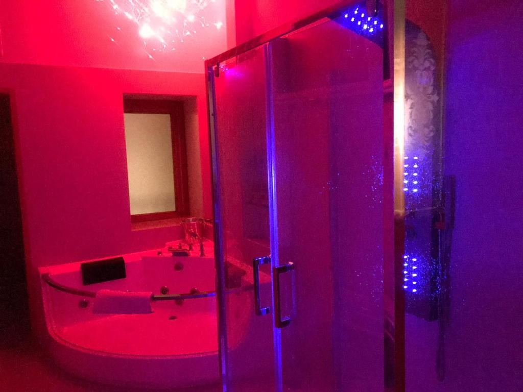 a bathroom with a sink and a shower with purple lights at Amanda's Dream in Taranto