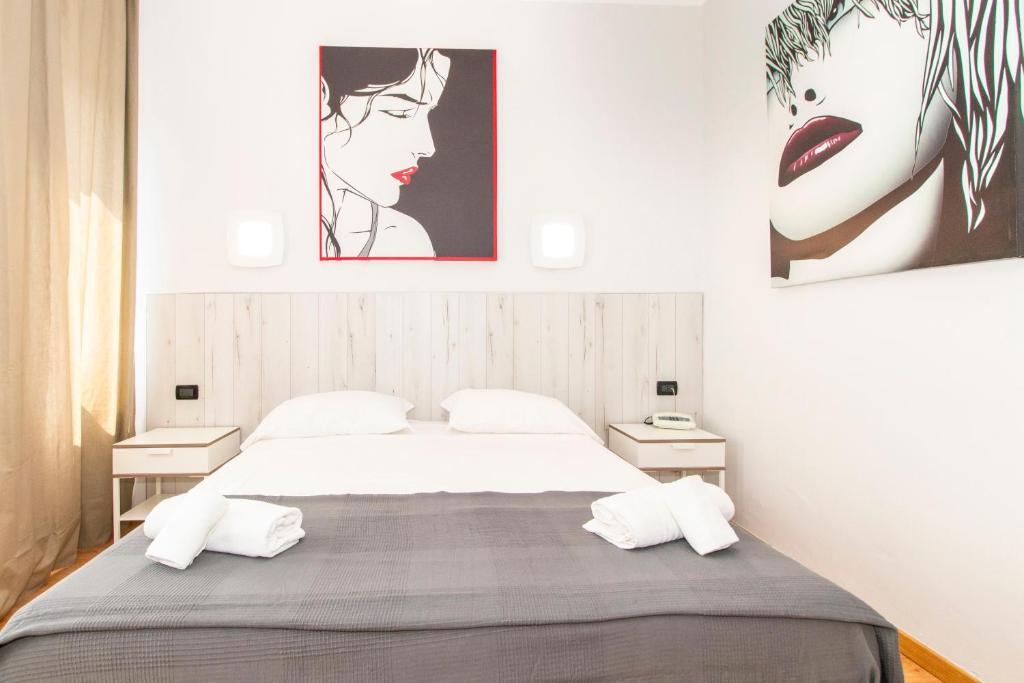 a bedroom with a large bed with two night stands at Hotel Cristallo Torino in Turin