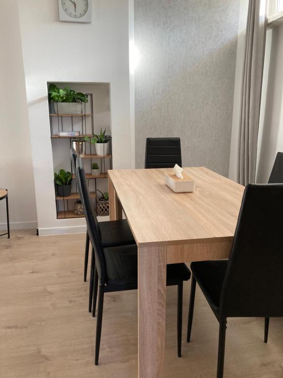 a dining room with a wooden table and chairs at Apartament Bulwar Nadmorski in Gdynia