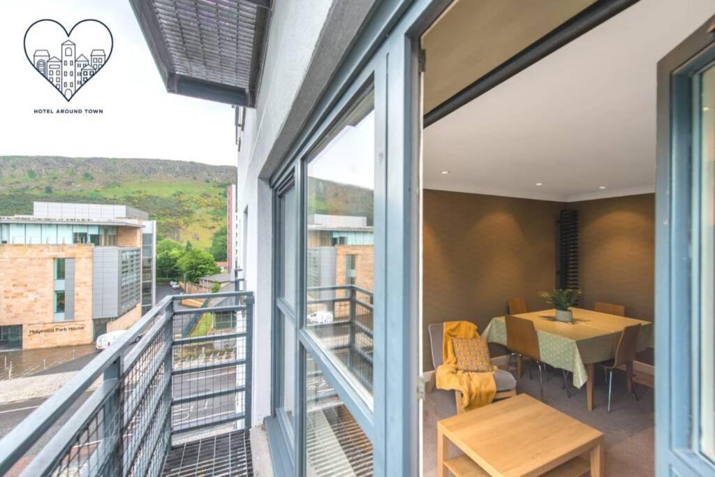a balcony with a table and a dining room at Royal Mile & Arthur's Seat Apt with Private Parking in Edinburgh