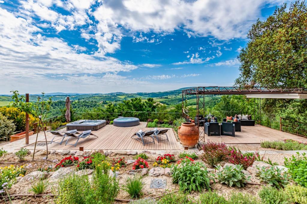 a patio with a table and chairs and a view at Villa Boccaccio in San Gimignano