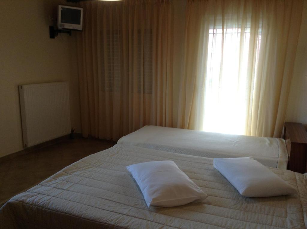 Postel nebo postele na pokoji v ubytování Guesthouse Lamprini