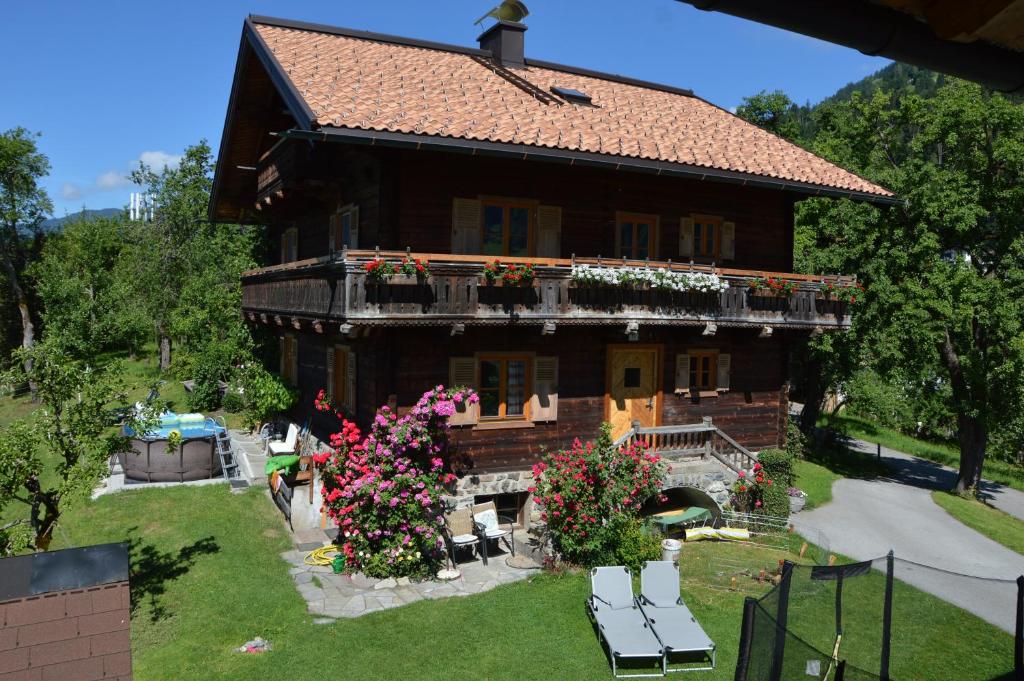 a large house with flowers in front of it at Ferienhaus Bognerhof in Sankt Veit im Pongau