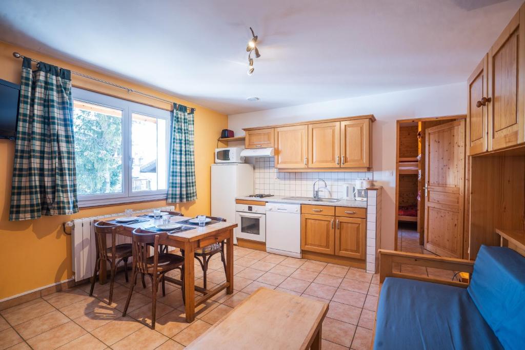 a kitchen with a table and a dining room at cellier 1 in Les Deux Alpes