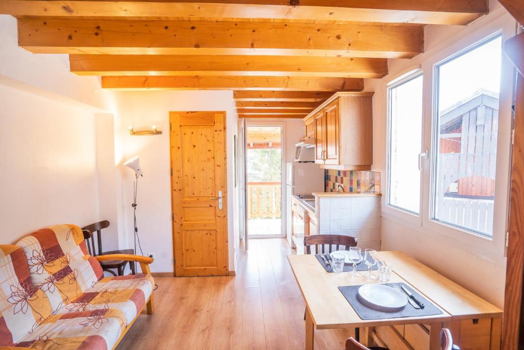 a small living room with a couch and a table at cellier 6 in Les Deux Alpes