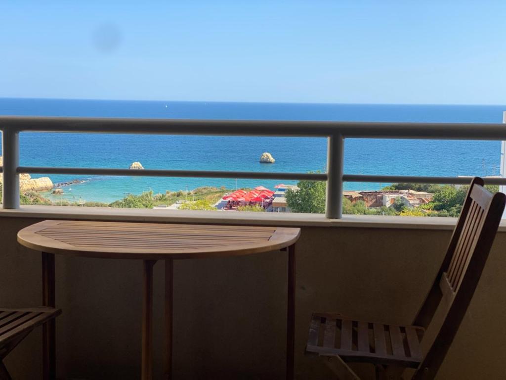 a balcony with a table and a view of the ocean at Studio Apartment Ocean View in Portimão