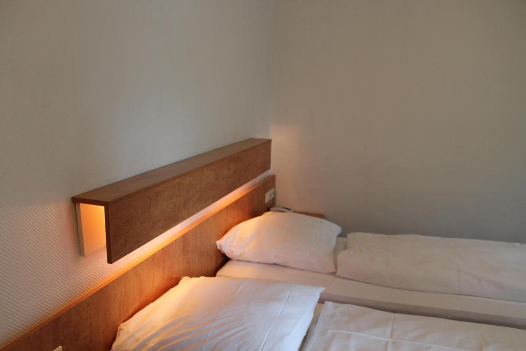 a room with two beds in a room with lights at Hotel Gasthof zur Linde in Rothenburg ob der Tauber