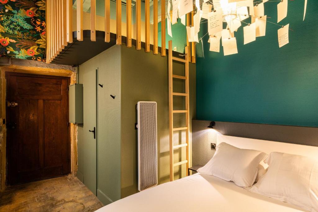 a bedroom with a bed and a ladder and a staircase at DIFY Platiere - Hotel de Ville in Lyon