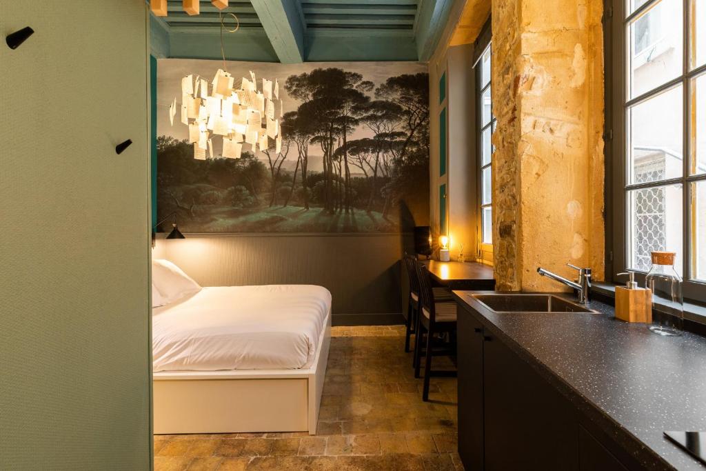a bedroom with a bed and a sink in a room at DIFY Platiere - Hotel de Ville in Lyon