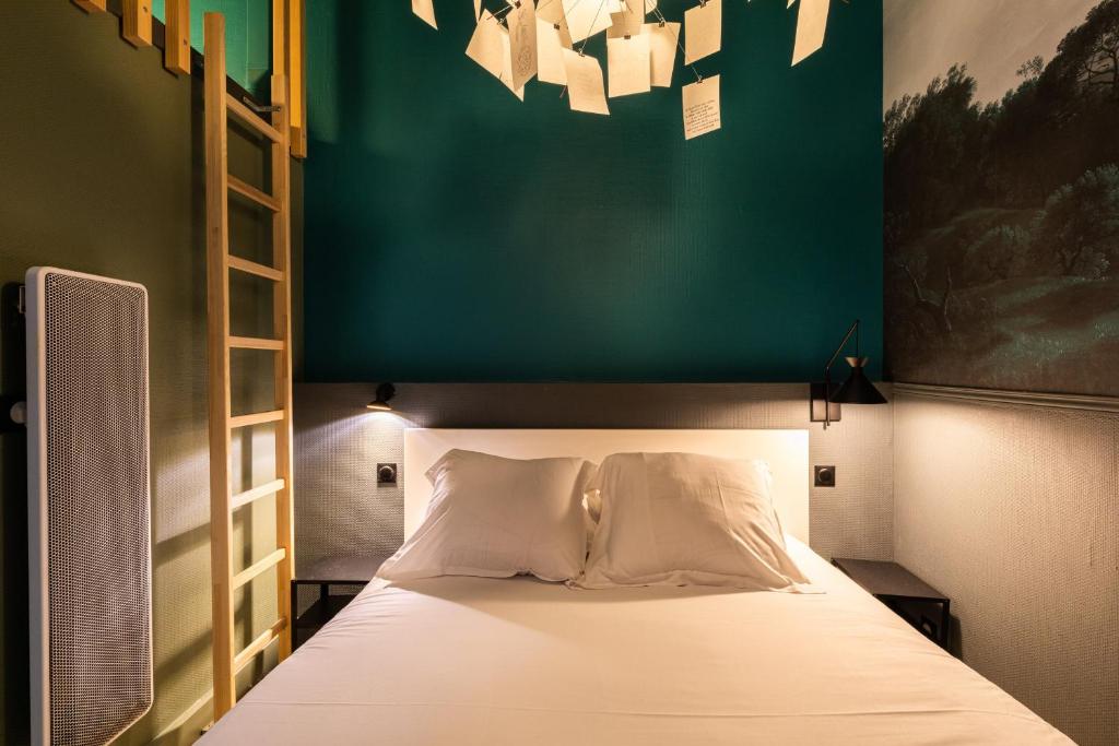 a bedroom with a bed with a green wall at DIFY Platiere - Hotel de Ville in Lyon