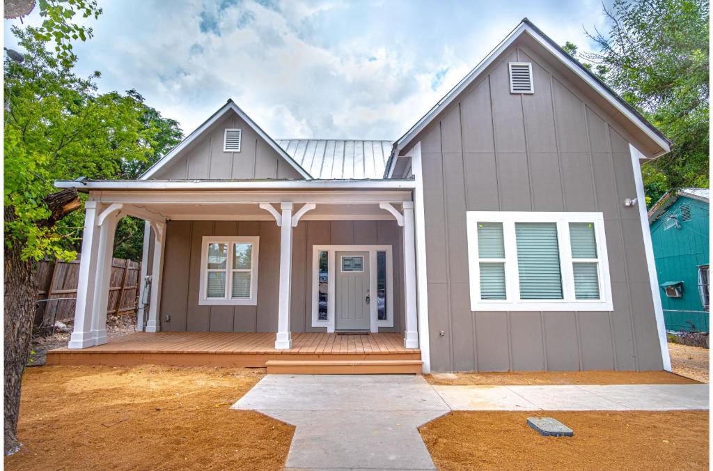 a home with a porch and a house at Brand New Remodeled 3BR2BA House Near Downtown in San Antonio