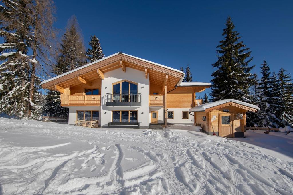 a log house in the snow with snow covered ground at Chalet Zillertal Arena in Krimml