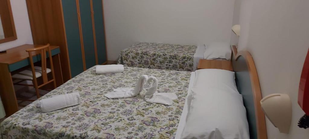 Postel nebo postele na pokoji v ubytování Hotel Santini