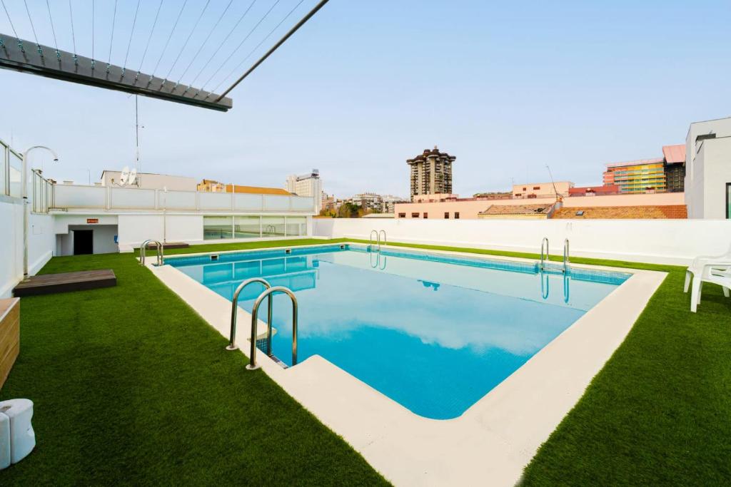 a swimming pool on the roof of a building at Magnificient Furnished Francisco Remiro Apartments in Guindalera in Madrid
