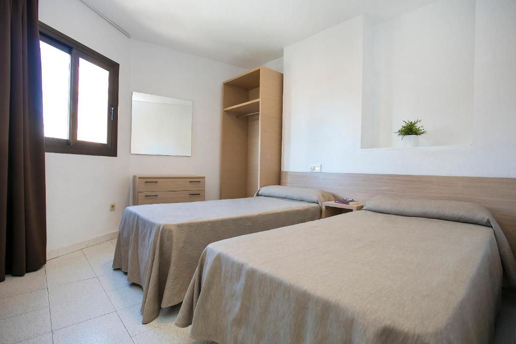 a hospital room with two beds and a window at Apartamentos Amalia By Mc in Benidorm