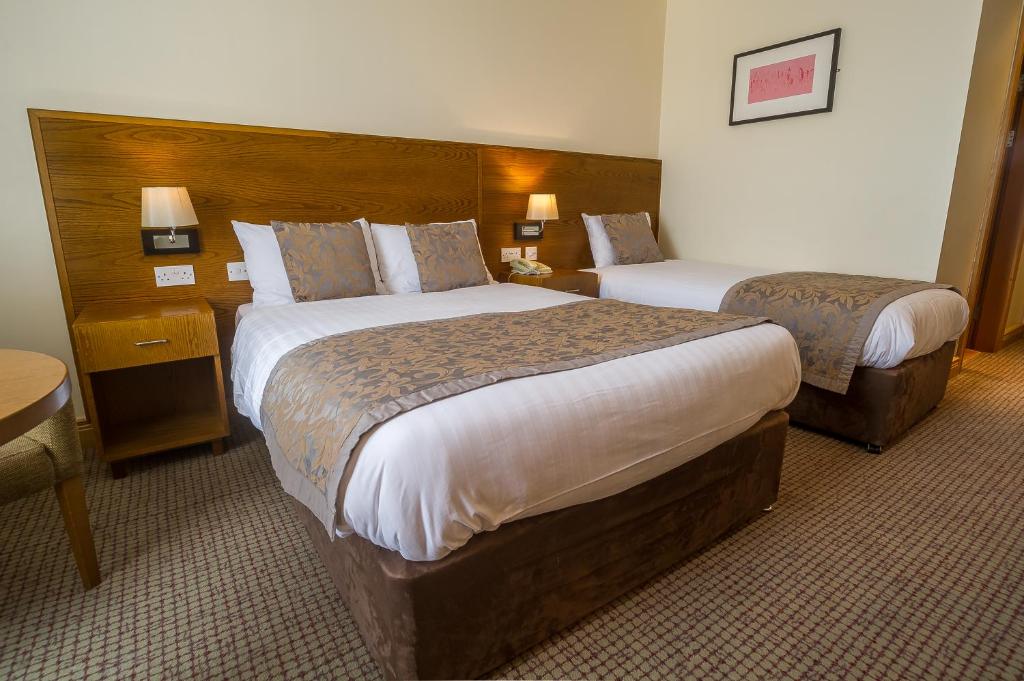 Letto o letti in una camera di The Carraig Hotel